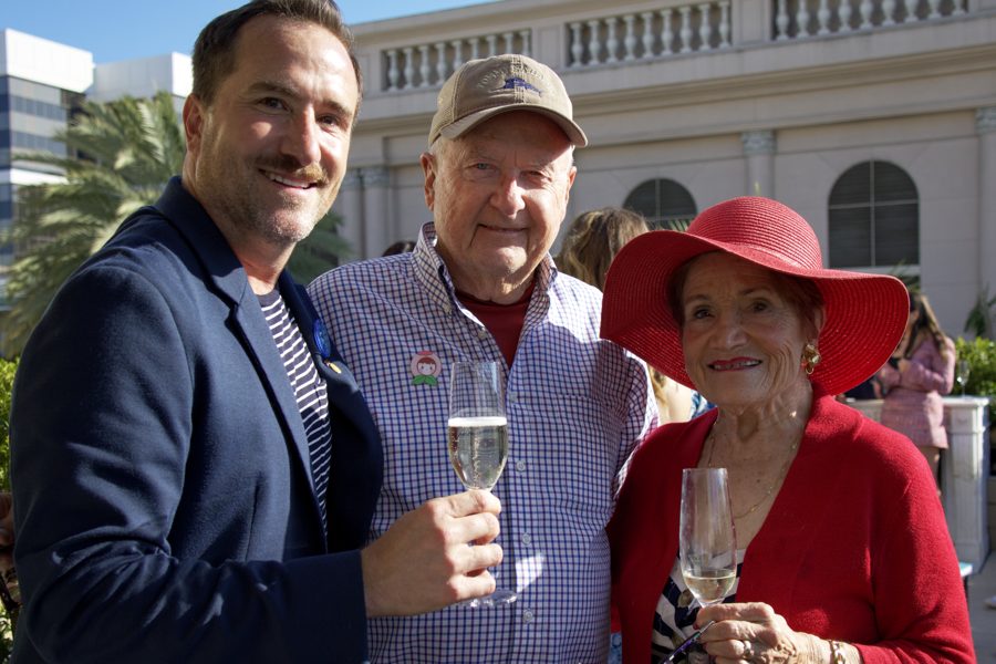 Brian toasting with champagne alongside two guests