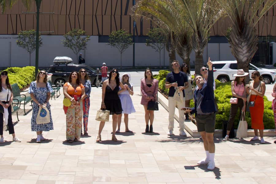 A large corporate group gathered in a Beverly Hills plaza