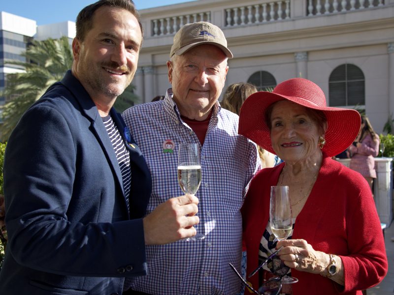 Brian toasting champagne with two guests