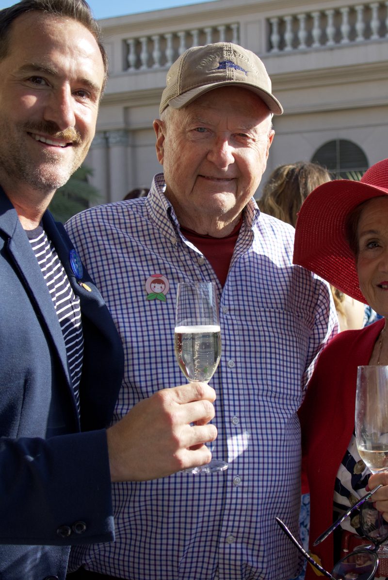 Brian toasting with champagne alongside two guests