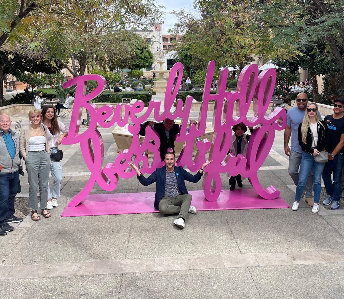 Brian and a group at the pink Beverly Hills Is Beautiful sculpture
