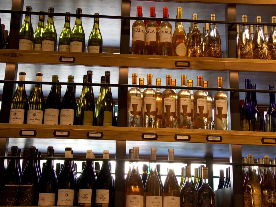 A backlit wall of French wines and rosés
