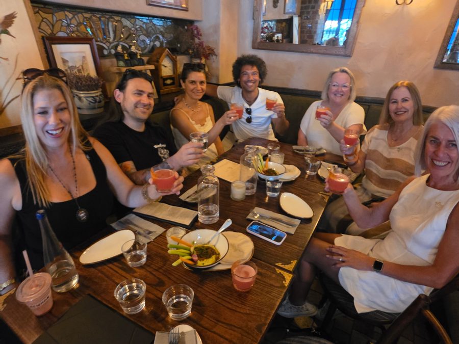 A private group toasting over shared plates