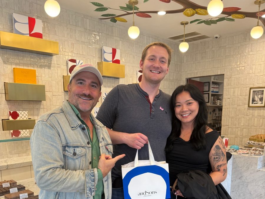 Brian with guests holding an andSons Chocolatiers gift bag